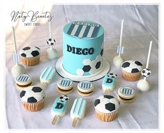 a cake and cupcakes on a table with soccer themed icing for decorations