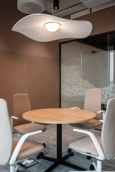 an office meeting room with chairs and a round table