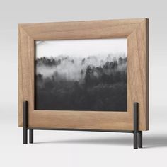 a wooden frame with a black and white photo in the middle on top of it