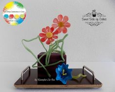 there is a vase with flowers in it on the tray and an advertisement for sweet stuff by cakes