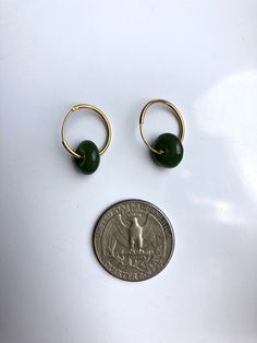 A stunning pair of modern-look dark green jade donut drop earrings.Simple and elegant. Hand-made from the premium 100% natural and real green nephrite green jades circle and 925 sterling silver plated with 18K gold in a minimalistic style. The stylish gold and green minimalistic design is great for your day-to-day classic wear or special occasions. Perfect as a gift for yourself or your loved ones. Some highlights of this pair of eye-catching genuine dark green jade drop earrings are: *High-qual Everyday Green Huggie Earrings, Handmade Jade Hoop Earrings, Green Huggie Earrings For Everyday Wear, Green Huggie Hoop Earrings For Everyday, Green Hypoallergenic Hoop Earrings For May Birthstone, Hypoallergenic Green Hoop Earrings For May Birthstone, Everyday Green Emerald Earrings, Minimalist Single Green Earring, Green Small Hoop Earrings For Everyday