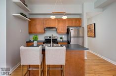 the kitchen is clean and ready to be used for cooking or eating, with stainless steel appliances