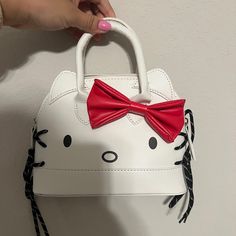 Nwot Cute Hello Kitty Satchel Crossbody Purse. Comes With Long Strap. Approx Largest Measurements: At Base: Wide 8.5”X Depth3.5”. Tall 6.5” Approx 3” Handle Drop. Comes With Longer Removable Crossbody Strap Vegan Leather White With Red Bow. Cool String Decorative Sides Trendy White Hello Kitty Bag, Playful White Bags With Hello Kitty Print, Trendy White Bag With Cat Design, White Playful Hello Kitty Print Bags, White Hello Kitty Print Bag, Playful White Hello Kitty Print Bag, Cute Hello Kitty Rectangular Shoulder Bag, Hello Kitty Mini Bag, Everyday Hello Kitty Kawaii Shoulder Bag