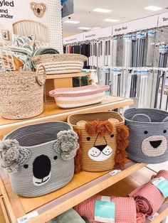 several baskets with animals on them in a store