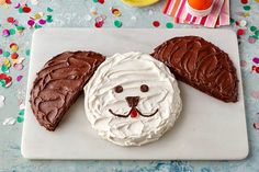 a cake shaped like a dog's face on a plate