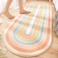 a woman standing on top of a rug in a bedroom next to a white bed