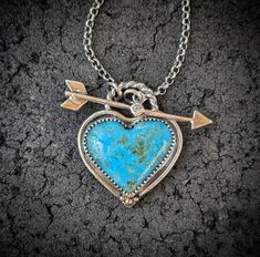 Genuine Kingman, Arizona turquoise heart is set in a handcrafted oxidized 925 sterling silver bezel with accents of 14k gold. Front closing arrow toggle closure features a Moissanite diamond for a touch of sparkle. Connects  to a 2.2mm medium weight and sturdy rolo chain.  ~Turquoise D 24mm x 28mm (Large size with inclusions of pyrite) ~Turquoise E 28mm x 34mm (Extra large size with tiny inclusions of pyrite) ~Natural untreated American mined stones ~Wrapped in black gift box ~Handmade in Tennes Artisan Heart-shaped Jewelry For Anniversary, Artisan Heart Shaped Jewelry For Crafting, Heirloom Sterling Silver Jewelry With Heart Charm, Unique Hand Forged Heart Pendant Jewelry, Unique Hand Forged Heart Pendant, One Of A Kind Heart Jewelry For Anniversary, One Of A Kind Turquoise Jewelry For Anniversary, Heirloom Sterling Silver Jewelry For Valentine's Day, Artisan Jewelry With Heart Charm As Gift