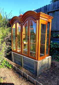 an old wooden building with glass doors in the front and side windows on each side