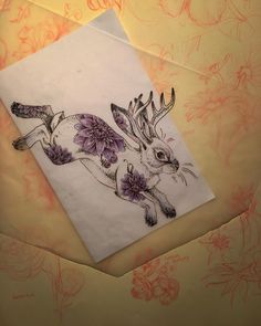 a drawing of a deer with flowers on it