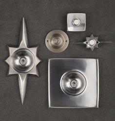 several metal objects are arranged on a gray surface