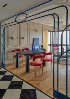 a dining room with red and blue chairs