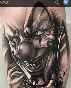 a close up of a person with a tattoo on his leg and a clown face