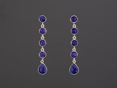 This pair of five-tier, long dangle sapphire earrings would be a nice reward for yourself or a great gift for your mother or best friend. Each one has five sapphire stones set in gold plated bezels and connected in tandem. 1. Stones : sapphire 2. Stone shape and size:              top four tier: 7 mm round              bottom stone :  12 x 9 mm pear 3. earring total length ~ 60 mm 4. bezel material: 24k gold vermail or sterling silver 5. earring post: 24k gold vermail or sterling silver 6. if se Blue Teardrop Chandelier Earrings For Anniversary, Blue Faceted Long Drop Jewelry, Blue Dangle Chandelier Earrings For Anniversary, Elegant Blue Sterling Silver Linear Earrings, Elegant Long Drop Blue Jewelry, Elegant Blue Nickel-free Linear Earrings, Elegant Blue Teardrop Linear Earrings, Elegant Handmade Blue Linear Earrings, Blue Gemstone Chandelier Drop Earrings