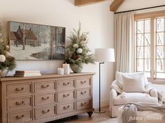 the living room is decorated for christmas with white furniture and holiday wreaths on the dresser