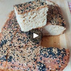 a loaf of sesame seed bread on a cutting board