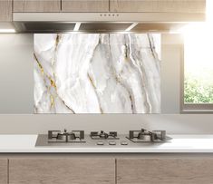 a kitchen with white and gold marble on the wall