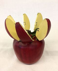 a red apple with two pieces cut out of it's core and sitting on a white surface