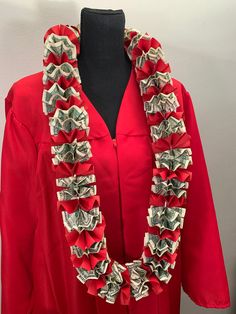 a red graduation gown with dollar bills on the front and neck, along with a black mannequin