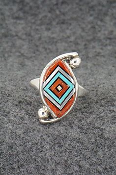 This beautiful turquoise, onyx, mother of pearl, coral and sterling silver inlay pendant and ring ring set was made by Zuni silversmith Vernon Vacit. The set is signed V. Vacit.Pendant Length: 1 1/2"Pendant Width: 1"Ring:Size: 9.5Length: 1 1/8"Width: 1/2"Free shipping on all orders! We ship with USPS and always include tracking. All orders ship within a day of payment.Returns are accepted up to 30 days after you receive your order. Just send us a message. Our shop offers cash back or store credi Red Inlay Ring Jewelry, Multicolor Polished Finish Ring Jewelry, Multicolor Polished Ring Jewelry, Red Ring With Inlay, Red Inlay Ring, Red Sterling Silver Ring With Inlay, Red Sterling Silver Rings With Inlay, Unique Inlay Ring Jewelry, Red Sterling Silver Jewelry With Inlay