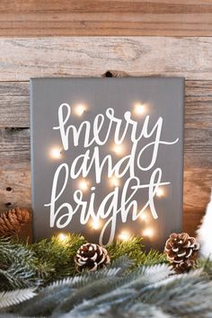 a merry and bright sign surrounded by pine cones