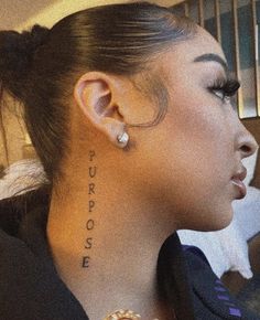 a woman with a tattoo on her neck