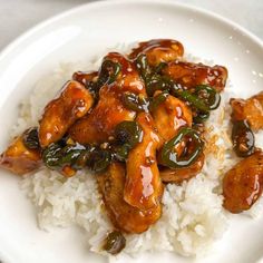 a white plate topped with rice and chicken