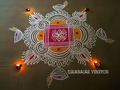 an intricate design on the ground with candles