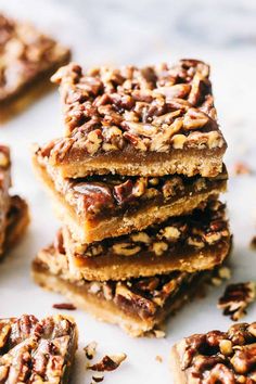 several pieces of pecan bar stacked on top of each other with nuts in the middle