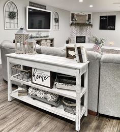 a living room filled with furniture and a flat screen tv mounted to the side of a wall