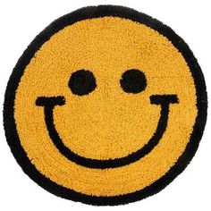 a yellow and black smiley face door mat