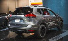 the rear end of a silver suv on display