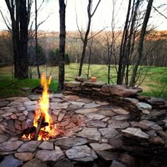 an outdoor fire pit with rocks around it