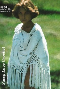 a woman wearing a white crocheted shawl with fringes