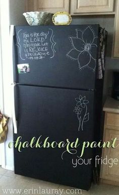 a black refrigerator with chalkboard paint on it