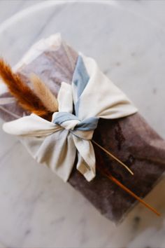 a piece of chocolate wrapped in brown paper with a bow