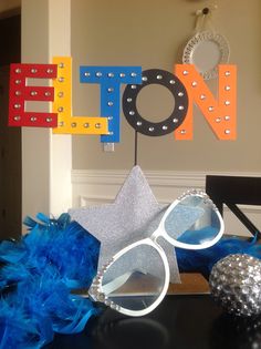 a table topped with glasses and decorations next to a sign that says efoon