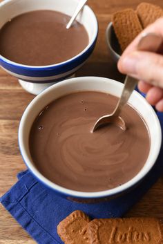 two bowls filled with chocolate and some crackers