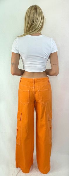 See things in color! These fun cotton cargo pants are the perfect trend in color. The flattering low-rise fit with wide legs and side snap pockets are just what you need to hit the streets. Pair this trend with a cute crop or your favorite tee and sneakers for a fun look. Color- Orange ( Also Available in Red) 100% Cotton Relaxed Fit Cropped Bottoms For Streetwear, Trendy Spring Cargo Jeans With Pockets, Casual Mid-rise Cargo Pants For Summer, Trendy Spring Cargo Jeans, Summer Urban Cargo Pants With Hip Pockets, Y2k Style Cotton Cargo Pants With Pockets, Trendy Relaxed Fit Mid-rise Cargo Pants, Trendy Spring Cargo Jeans With Multiple Pockets, Trendy Cargo Jeans With Multiple Pockets For Spring