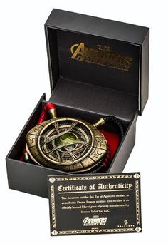 an award is presented in a black box with gold trimmings and a red ribbon