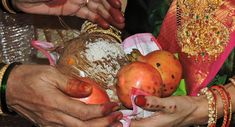 two people holding different types of fruit in their hands