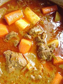 meat and vegetable soup in a pot on the stove