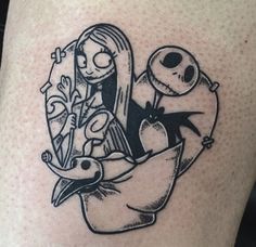 a cartoon tattoo on the leg of a person with a bird and jack skellingy