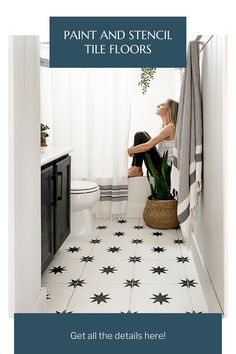 a woman sitting on top of a toilet next to a bathroom floor with black and white stars