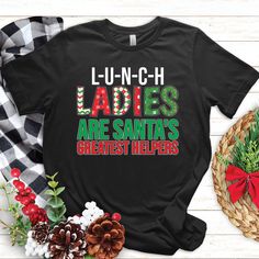 Spread holiday cheer with Christmas Lunch Lady shirts! Perfect for cafeteria workers, dinner ladies, and food service professionals. Join the cafeteria crew in festive style We at TempusVitae always strive for perfection in creating the designs that are brought to life through our carefully selected lightweight material apparel. Enhanced durability is achieved by using double-needle stitches both on sleeves and bottom hem. Solid color printing guarantee the design remains unaltered even after several washings. All shirts are made from 100% ring-spun cotton with: * Shoulder-to-shoulder taping * Side-seamed * Tear-away label * Machine washable durable material * Unisex sizing Our t-shirts feel soft and light, with just the right amount of stretch. It's comfortable and the unisex cut is flatt Christmas Shirts Diy, Lunch Lady Shirts, Shirts Diy, Lunch Lady, School Cafeteria, Christmas Lunch, Food Service, Work Shirts, Christmas Shirt