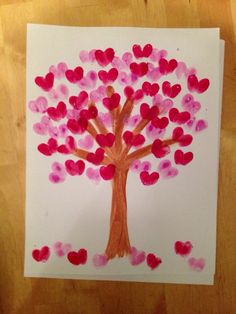 a child's drawing of a tree with hearts on it