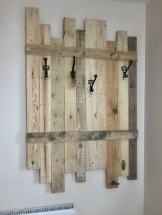 a wooden wall mounted to the side of a white wall next to a radiator