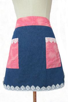 a mannequin wearing a blue and pink skirt with white lace trimmings