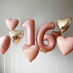 pink and gold balloons with the word love spelled out in large, heart - shaped letters