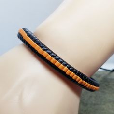 If you like orange and black, then this simple bracelet is perfect for you to add to your collection. The bracelet is adjustable via a sliding knot. Product Information Material: PU leather Clasp Type: rope (sliding knot) Adjustable: 6.5 inches to 8 inches Casual Adjustable Bracelet With Black Band, Black Leather Bracelet With Adjustable Cord As Gift, Casual Orange Braided Bracelets For Friendship, Casual Orange Braided Bracelet For Friendship, Casual Adjustable Black Band Bracelet, Black Beaded Bracelet With Sliding Knot For Friendship, Trendy Black Braided Bracelets With Sliding Knot, Friendship Black Beaded Bracelet With Sliding Knot, Black Adjustable Braided Bracelet With Sliding Knot