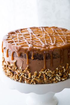 a cake with chocolate frosting and nuts on top